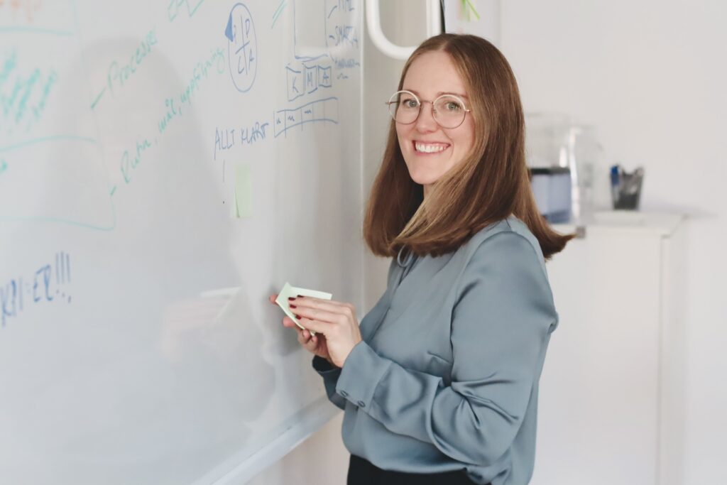 kvinna vid whiteboardtavla